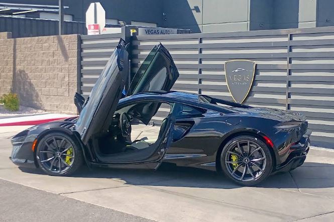 Black sports car with open doors, cleaned and detailed